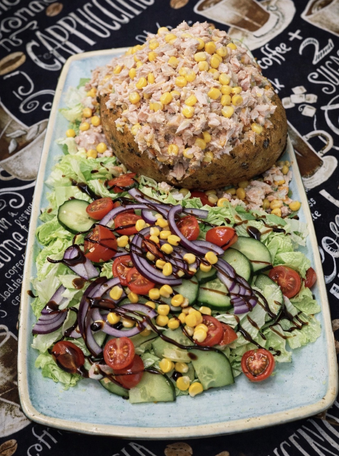 Jacket potato topped with tuna mayo and sweetcorn, served with salad